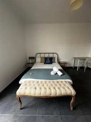 a bedroom with a large bed with a green blanket at Apartments near Ramblas - Only for stays over 32 days in Barcelona