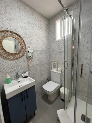 a bathroom with a toilet and a sink and a mirror at Apartments near Ramblas - Only for stays over 32 days in Barcelona