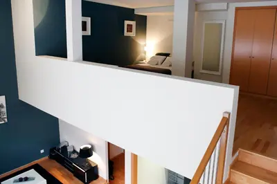 a staircase leading up to a room with a bed at Fira Duplex in Hospitalet de Llobregat