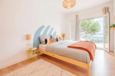 a bedroom with a bed and a large window at Villa Nova Vida Barcelona in Teià