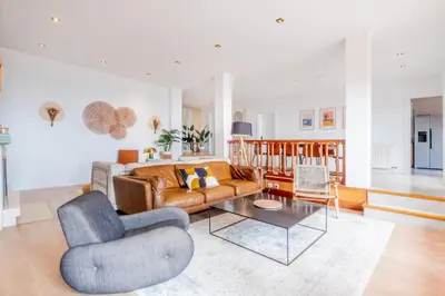 a living room with a couch and a table at Villa Nova Vida Barcelona in Teià