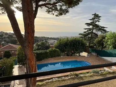 a swimming pool in a yard with a tree at Villa Nova Vida Barcelona in Teià