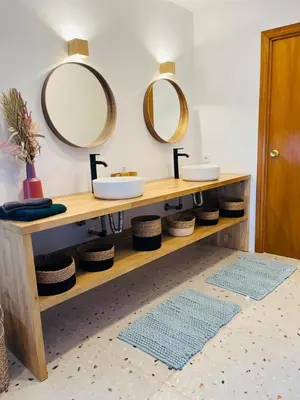 a bathroom with two sinks and two mirrors on the wall at Villa Nova Vida Barcelona in Teià