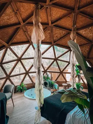 a room with a bed in a large wooden ceiling at Bubble Suites in Canyelles