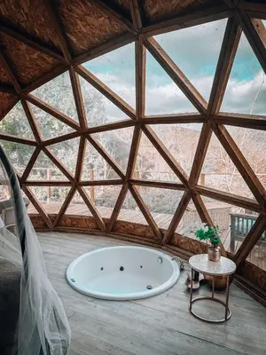 a large room with a large window with a bath tub at Bubble Suites in Canyelles