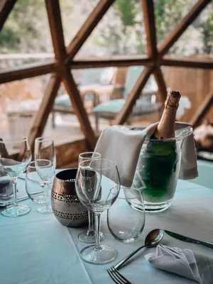 a table with wine glasses and a bottle on it at Bubble Suites in Canyelles