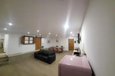 a living room with a black couch and a table at Villa Urbina in Olerdola