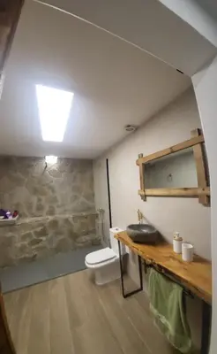 a bathroom with a sink and a toilet at Villa Urbina in Olerdola