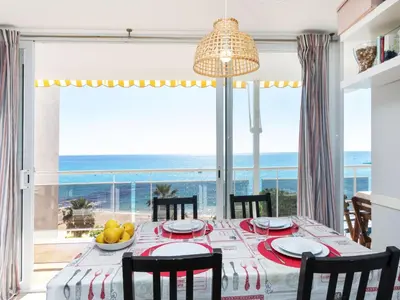 a dining room with a table and chairs and a large window at Apartment Clipper by Interhome in Sant Vicenç de Montalt
