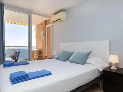a bedroom with a bed with a view of the ocean at Apartment Clipper by Interhome in Sant Vicenç de Montalt