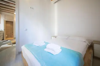 a bedroom with a bed with towels on it at Catalunya Casas Lovely apartment central Barcelona 100m to beach! in Barcelona