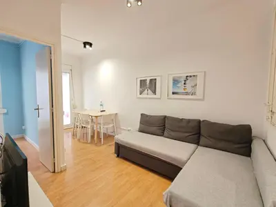 a living room with a couch and a table at Cozy apartment in Gracia in Barcelona