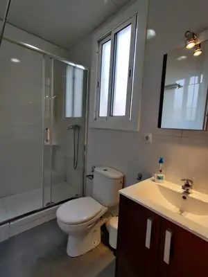 a bathroom with a toilet and a shower and a sink at Cozy apartment in Gracia in Barcelona