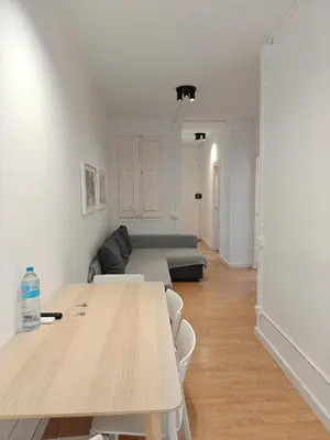 a living room with a table and a couch at Cozy apartment in Gracia in Barcelona
