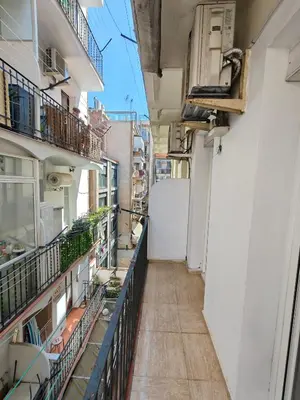 an alley between two buildings with balconies at Cozy apartment in Gracia in Barcelona