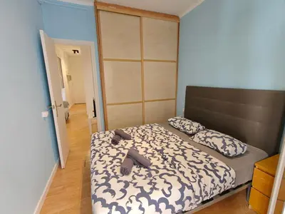 a bedroom with a large bed with a brown headboard at Cozy apartment in Gracia in Barcelona