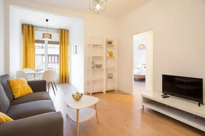 a living room with a couch and a tv at Stay U-nique Apartments Gaudi I in Barcelona