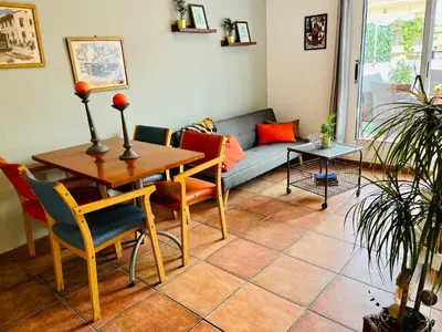 a living room with a table and a couch at Calm Terrace Barcelona in Barcelona
