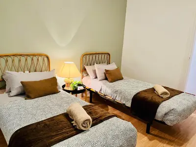 two beds sitting in a room with a lamp at Calm Terrace Barcelona in Barcelona