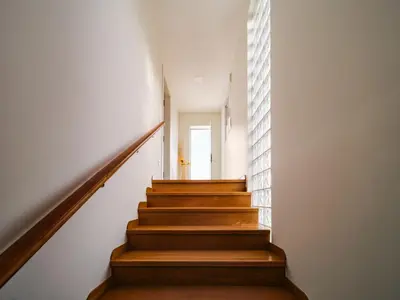 a staircase in a house with white walls and wooden floors at Villa Elena in Pineda de Mar