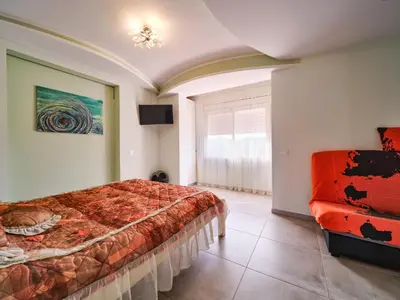 a bedroom with a bed and a couch at Villa Elena in Pineda de Mar