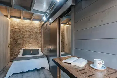a bedroom with a bed and a table with a coffee cup at Stay U-nique Apartment Tamarit II in Barcelona