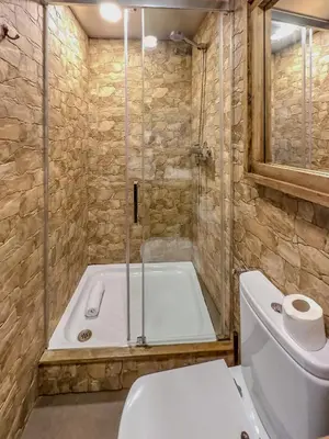 a bathroom with a shower and a toilet and a tub at Stay U-nique Apartment Tamarit II in Barcelona