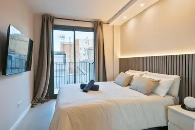 a bedroom with a bed with a teddy bear on it at bonito piso cerca del campo de futbol de barcelona in Hospitalet de Llobregat