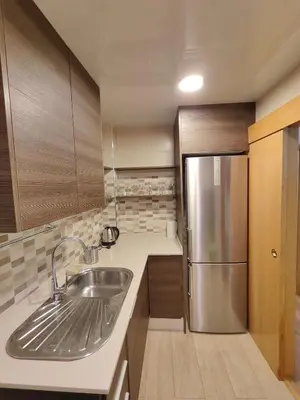 a kitchen with a sink and a refrigerator at Family apartment Besos 2 in Sant Adria de Besos
