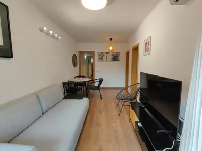 a living room with a couch and a flat screen tv at Family apartment Besos 2 in Sant Adria de Besos