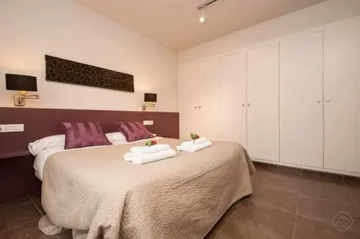 a bedroom with a large bed with towels on it at Port I Espectacular apartament con terraza in Barcelona