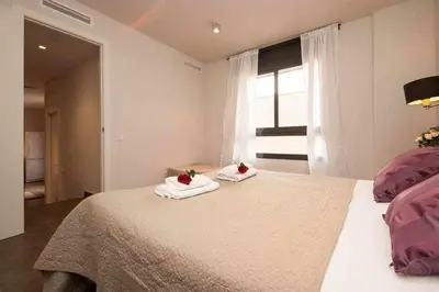 a bedroom with a large bed with towels on it at Port I Espectacular apartament con terraza in Barcelona