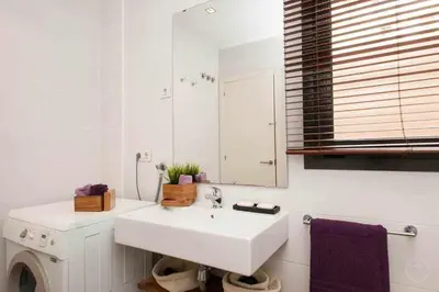 a white bathroom with a sink and a mirror at Port I Espectacular apartament con terraza in Barcelona