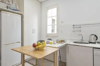 a kitchen with a bowl of fruit on a table at Canela Homes BARCELONA FONTANA in Barcelona
