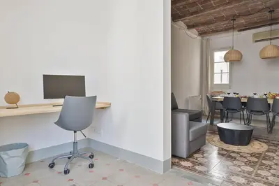 a room with a desk and a table with chairs at Canela Homes BARCELONA FONTANA in Barcelona