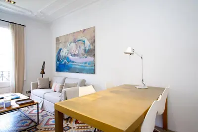a living room with a table and a couch at BarcelonaForRent The Claris Suites I in Barcelona