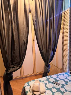 a room with a bed with black curtains at Bonita Habitación en chalet in Barcelona