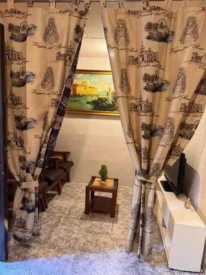 a living room with curtains and a table at Bonita Habitación en chalet in Barcelona