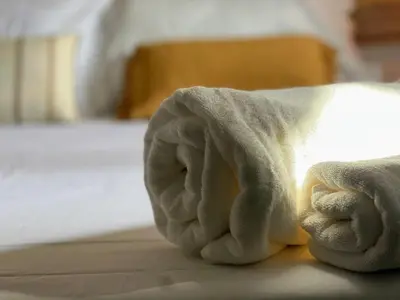 a towel laying on top of a bed at Loft acogedor cerca de Barcelona in Terrassa