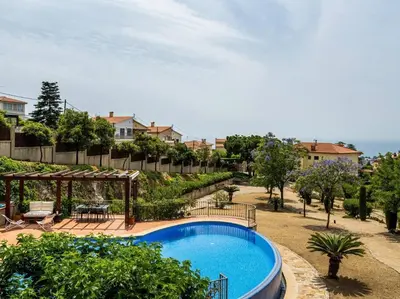 a large swimming pool in a yard next to a house at Architectural jewel between sea and mountains in Teià