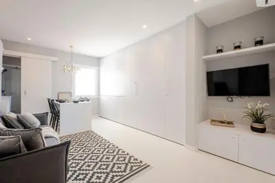 a living room with white walls and a flat screen tv at Stay U-nique Apartments Rambla Catalunya III in Barcelona