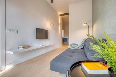 a living room with a couch and a tv on a wall at Stay U-nique Apartments Rambla Catalunya III in Barcelona