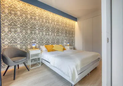 a bedroom with a large bed and a chair at Stay U-nique Apartments Rambla Catalunya III in Barcelona