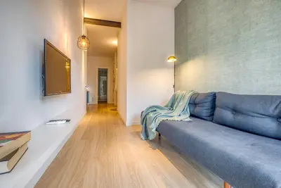 a living room with a blue couch and a television at Stay U-nique Apartments Rambla Catalunya III in Barcelona