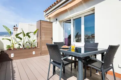 a patio with a table and chairs on a balcony at Stay U-nique Apartments Rambla Catalunya IV in Barcelona