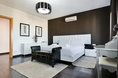 a bedroom with a white bed and a chair at Stay U-nique Apartments Rambla Catalunya IV in Barcelona