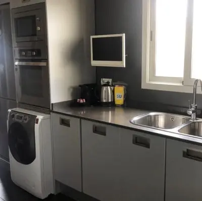 a kitchen with a sink and a stove and a microwave at Stay U-nique Apartments Rambla Catalunya IV in Barcelona