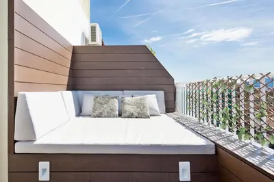 a bed on the balcony of a house at Stay U-nique Apartments Rambla Catalunya IV in Barcelona