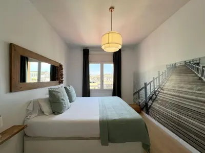 a bedroom with a bed with a window and a staircase at Stay U-nique Apartments Rambla Catalunya V in Barcelona