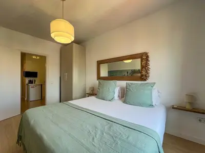 a bedroom with a large bed and a mirror at Stay U-nique Apartments Rambla Catalunya V in Barcelona